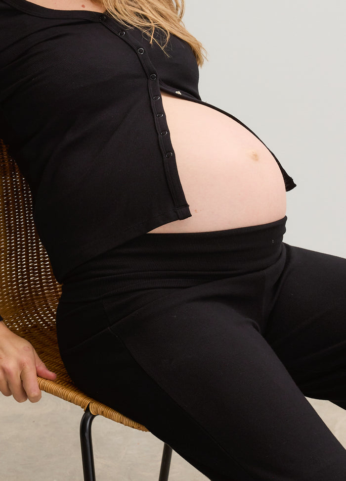 Black ribbed maternity top and leggings set showing pregnant belly, soft stretchy fabric.