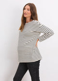 Black and ivory striped long-sleeve maternity top with bateau neckline worn by pregnant woman.