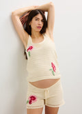 Cream ribbed maternity tank top with pink floral embroidery paired with matching drawstring shorts.