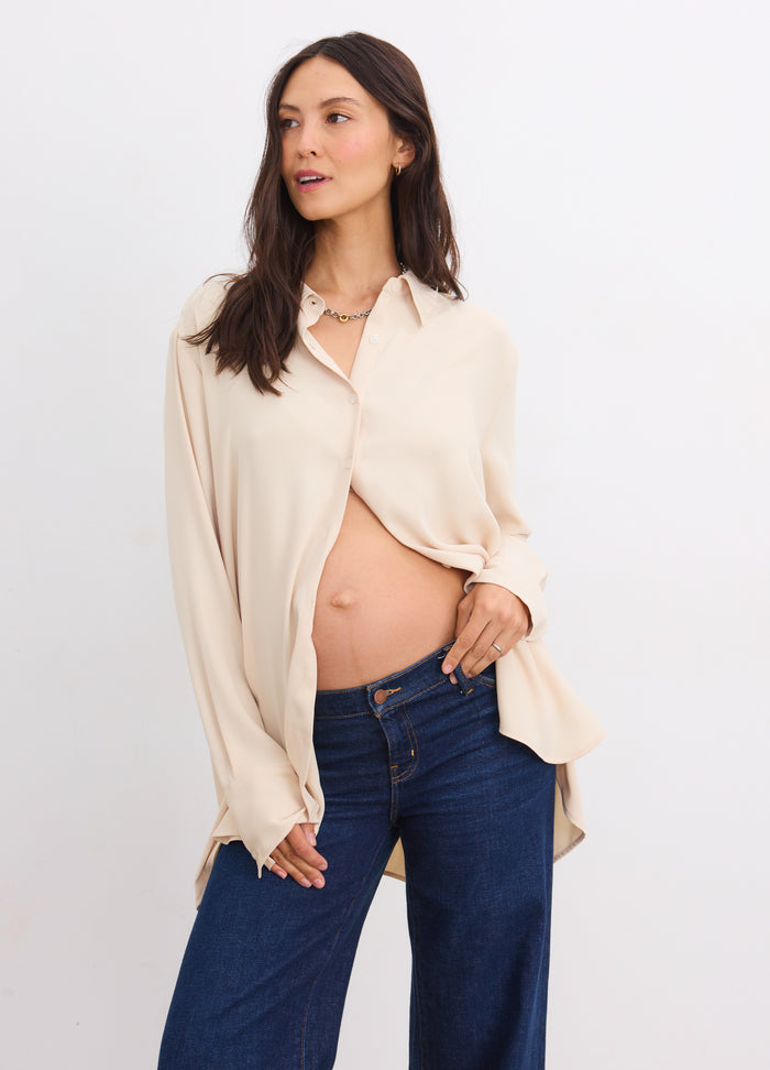Sandshell maternity buttondown with drapey fit worn open over pregnant belly, long sleeves, soft fabric.