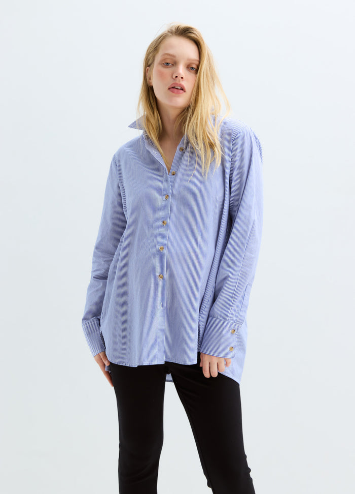 Light blue long-sleeve maternity buttondown shirt with front buttons and relaxed fit.
