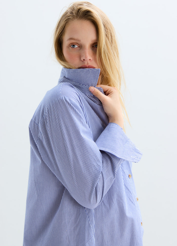 Light blue striped maternity buttondown shirt with long sleeves and a high collar.