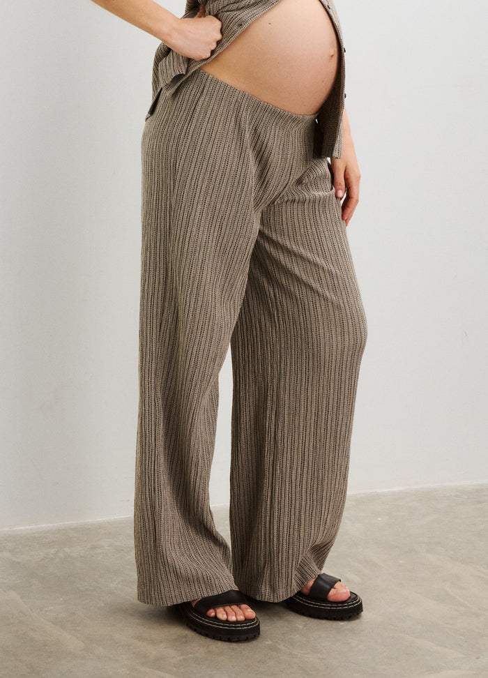 Taupe ribbed wide-leg maternity pants with adjustable waistband worn by pregnant model.