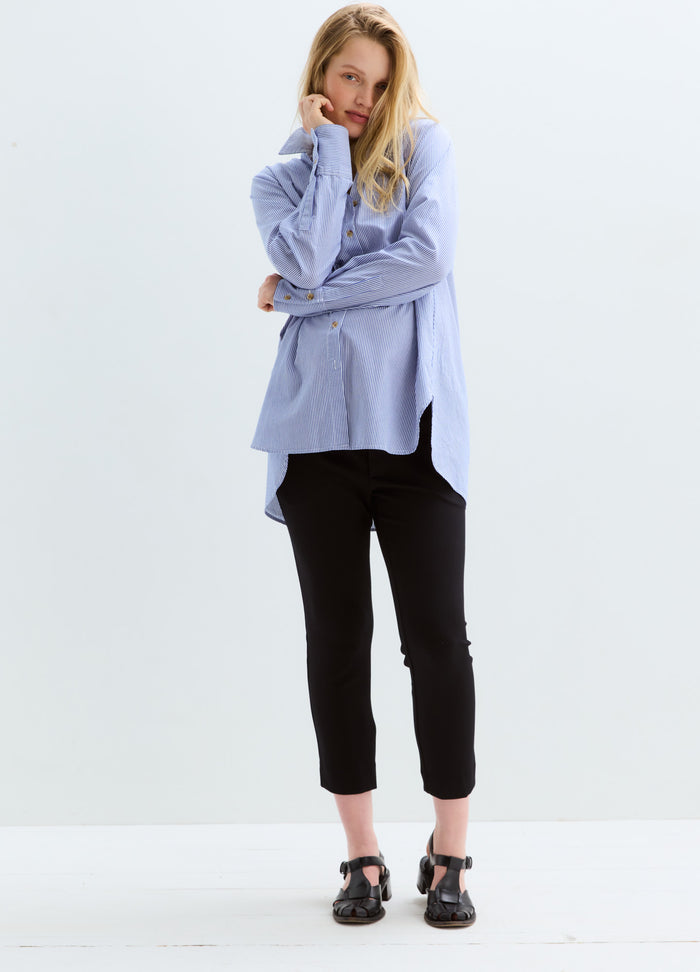 Black slim-fit stretch maternity suit pants with cropped ankles styled with a blue oversized shirt.