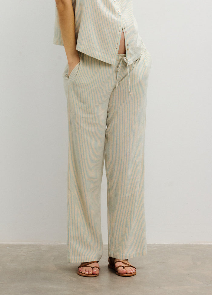 Light beige maternity pants with wide legs, adjustable drawstring waist, and soft fabric tailored for pregnant women.