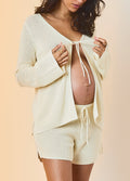 Cream knit maternity cardigan with tie-front and matching drawstring shorts.