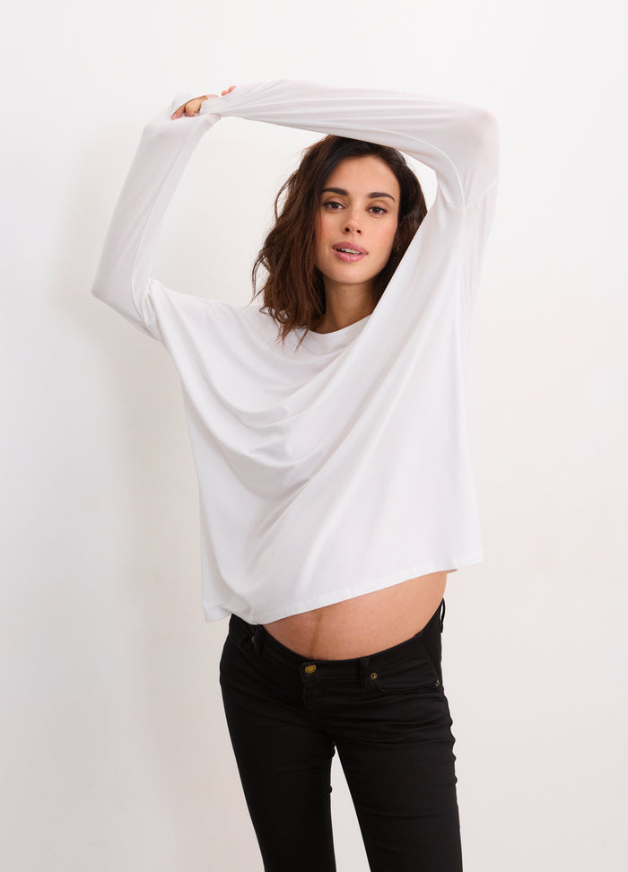 Soft white long sleeve maternity tee with relaxed fit and crew neckline.