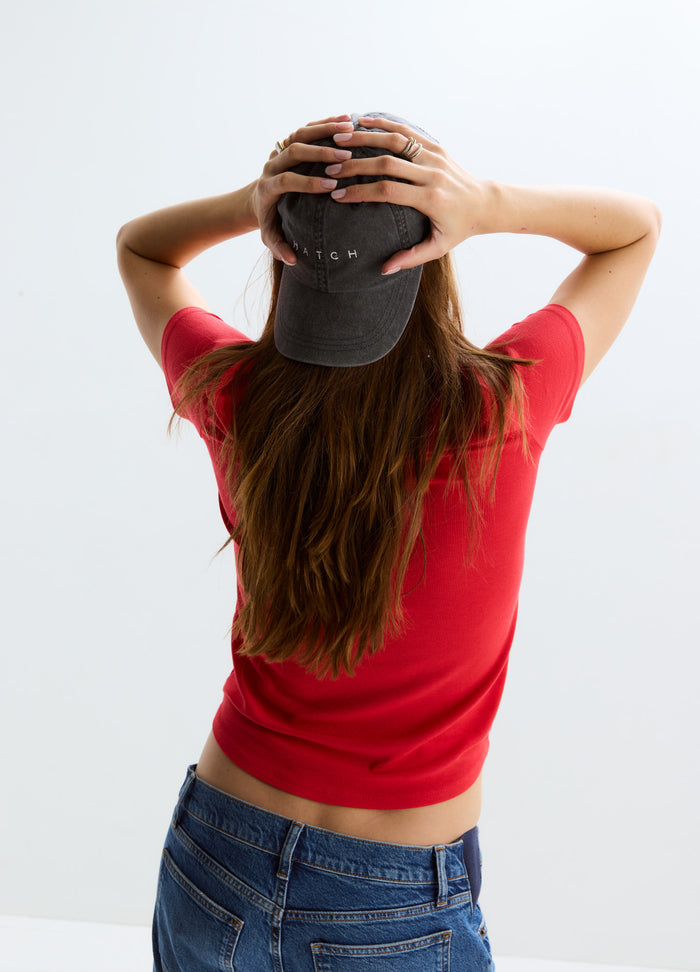 Red short-sleeve ribbed maternity tee with a fitted silhouette shown on a pregnant model from the back.