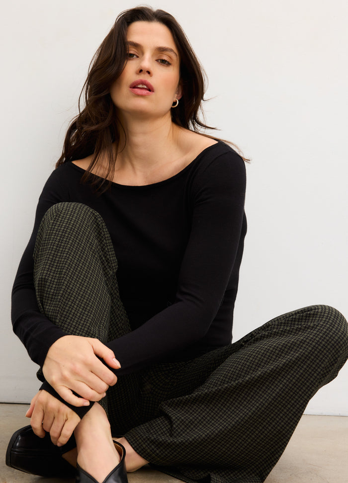 Black long-sleeve maternity top with off-shoulder neckline, worn by pregnant model.