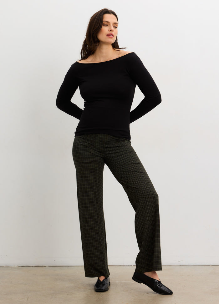 Black long-sleeve bodycon maternity top with off-shoulder neckline, paired with straight-leg olive pants and black flats.