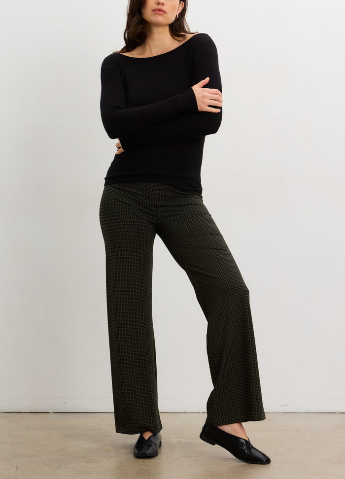 Black long-sleeve bodycon maternity top paired with olive wide-leg pants and black flats.