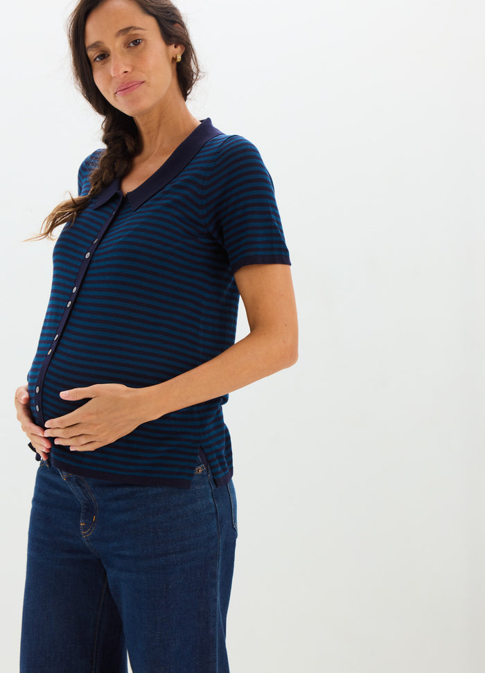 Navy blue and black striped short-sleeve maternity shirt with button front, fitted over pregnant belly.